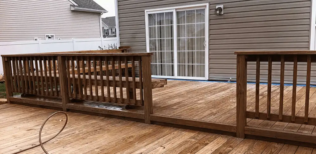 Deck sealing service protecting a backyard wood deck and railings in Oklahoma City, OK