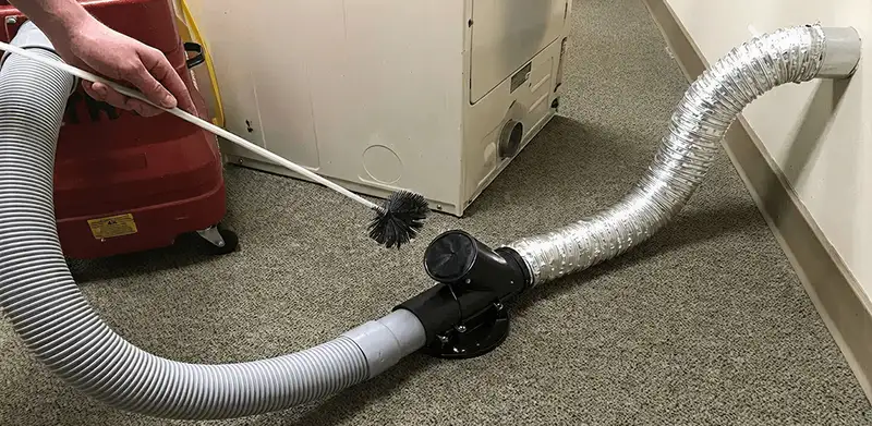 Dryer vent cleaning service removing lint from a dryer duct connection in Oklahoma City, OK