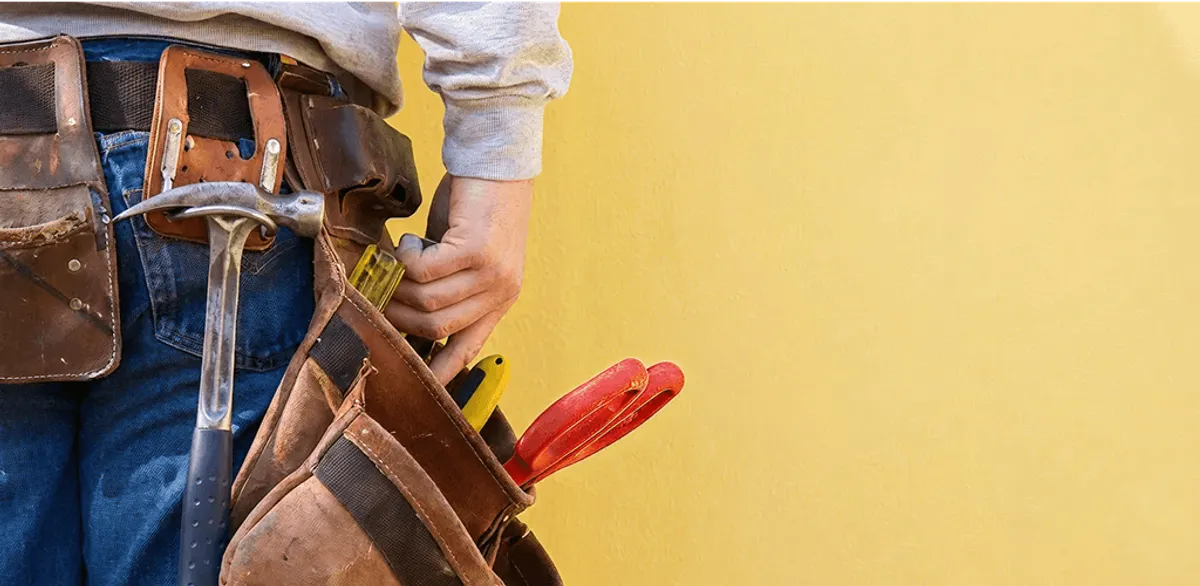 Handyman with tool belt ready for home repairs and maintenance in Oklahoma City, OK