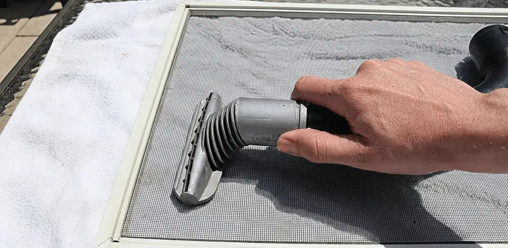 Window screen repair cleaning and fixing a damaged screen mesh in Oklahoma City, OK