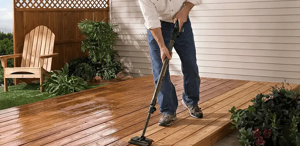 Deck staining service applying stain to a backyard wood deck in Oklahoma City, OK